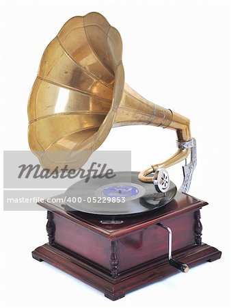 retro old gramophone for playing music over plates  isolated on white in studio