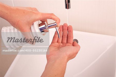 Squirting liquid soap into the palm of a hand
