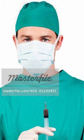 Young surgeon holding a syringe against a white background