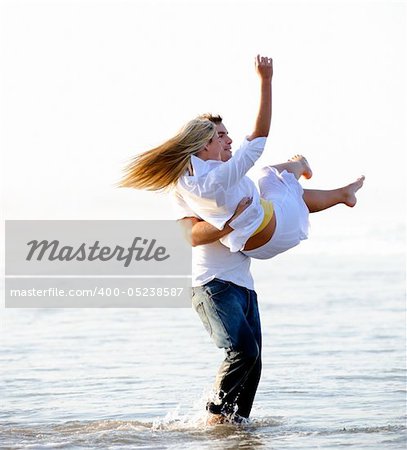 Young couple have fun in the ocean
