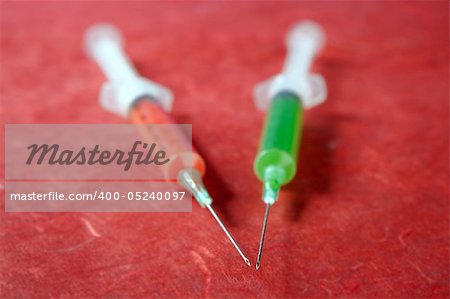 health still life red and green syringes over red background