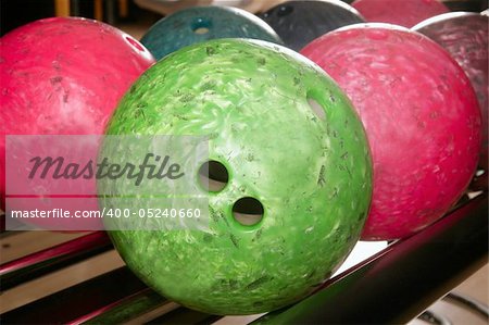 Bowling balls red green closeup row detail