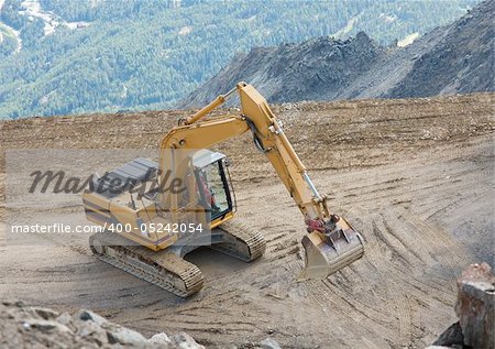 Construction machinery in a mountain landscape