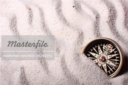 Sand background with compass