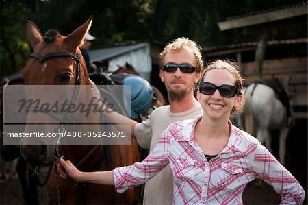 Equestrian couple posing on a horse ranch in Costa Rica