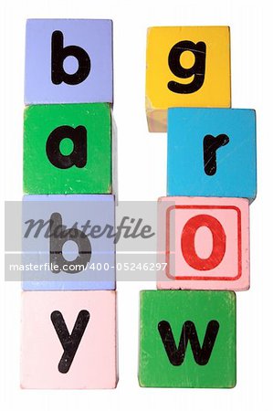 assorted childrens toy letter building blocks against a white background that spell baby grow with clipping path