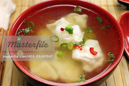 Delicious Chinese short soup with dumplings and diced shallots.