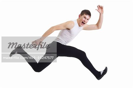 A young man runs with an expressive face and screams. Isolation on a white background in the studio.