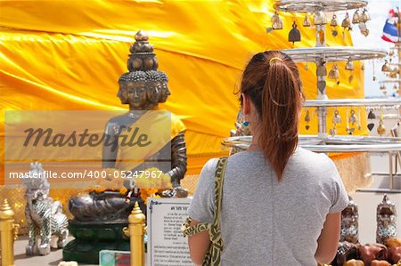 woman worship budda in the temple thai,worship thai faith budda