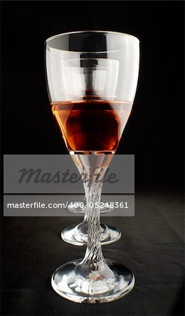 red wine in wineglasses on black