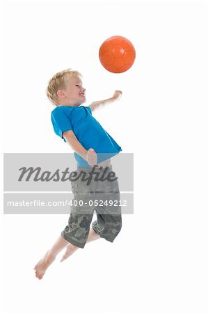 Young boy going to make a header. Will he score? Isolated on a white background. Little movement in arms and legs.