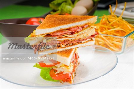 fresh and delicious classic club sandwich over a transparent glass dish