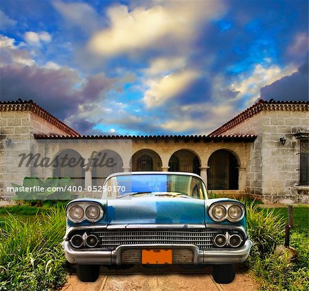 Front view in vintage american car parked in tropical residence, cuba