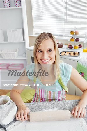 Cheerful woman baking in the kitchen at home
