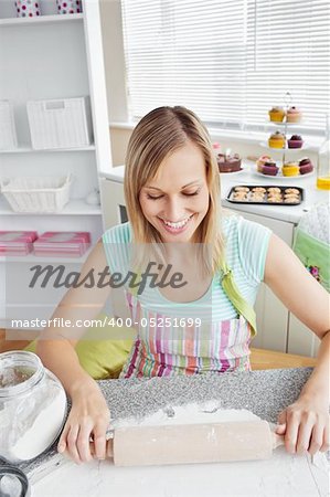 Smiling woman baking in the kitchen at home