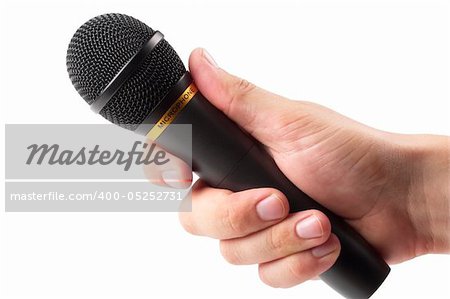 Black microphone in the hand isolated over white background