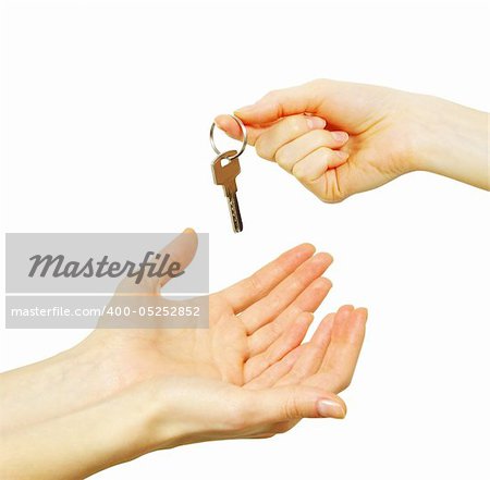 hand holds a key isolated on white