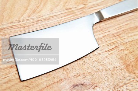 Stainless kitchen knife on wooden background