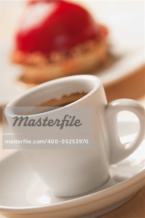 Close up picture of a cup of coffee and cake