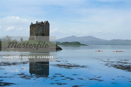 kayakers in sea canoes exploring castle stalker on small island in loch linnhe argyll in the scottish highlands kayakers in sea canoes exploring castle stalker on small island in loch linnhe argyll in the scottish highlands