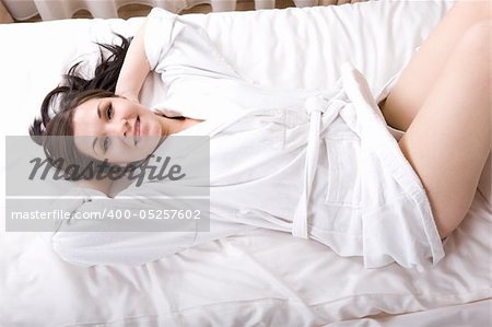 young adult brunette woman in bed