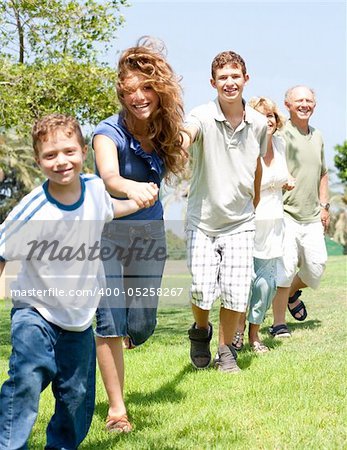 portrait of happy family making hand chain holding each other