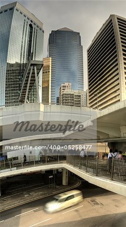 Cityscape of modern city with business skyscrapers and flyover in and one car on road in Hong Kong, China.