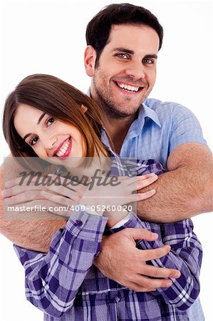 Closeup portrait of a cute young man hugging his wife from behind