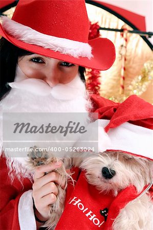 Santa claus with a white puppy in his arms.