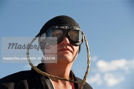 Man with knit cap, goggles and headdress