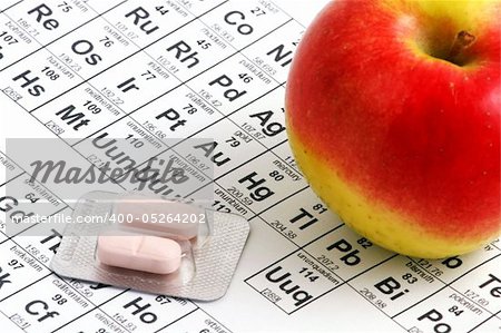 Macro of apple lying on periodic table