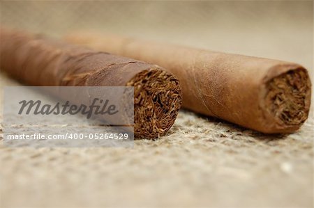 Two cuban cigars on hessian canvas