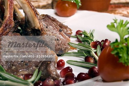 Fried rib served with pomegranate and salad