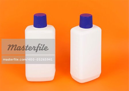 An image of nice white bottles on orange background