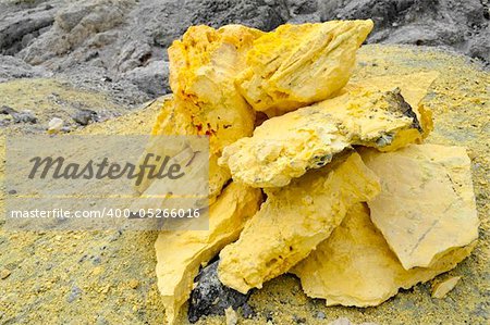 Yellow Sulphur stones beside a volcano landscape