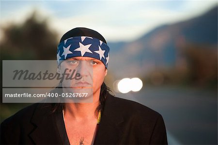 Handsome indigenous man by the side of the road