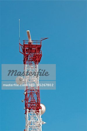Tall telecomunication tower against blue sky background