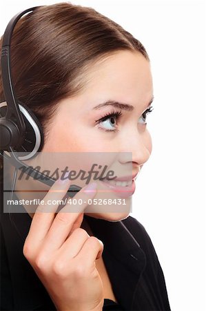 Pretty caucasian woman with headset smiling during a telephone conversation.