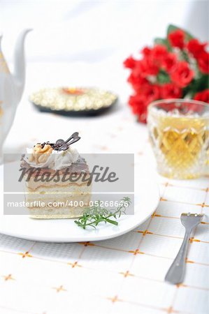 Chocolate dessert with tea, red roses and napkin