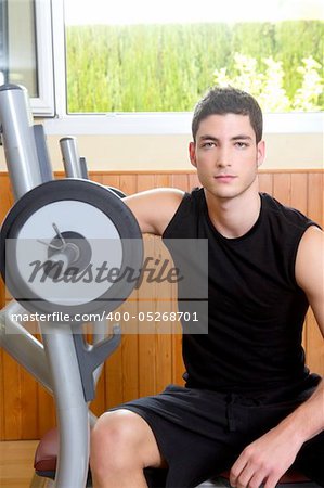 Gym young man posing body building weights black