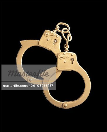 golden handcuffs isolated on black background