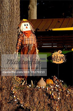 A halloween holiday scarecrow welcoming trick or treaters