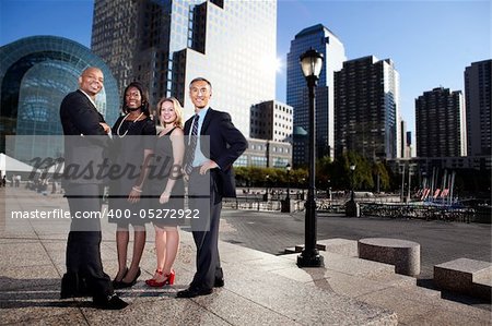 A successful business team in an outdoor setting against a city background