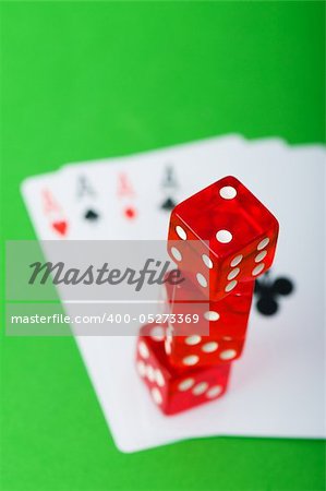 Casino chips and cards against green background