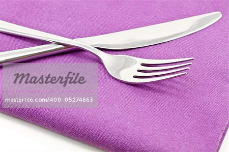 knife and fork on textile napkin