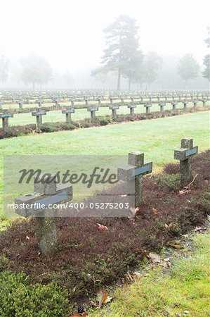 crosses at cemetery in autumn mist stone tombstones