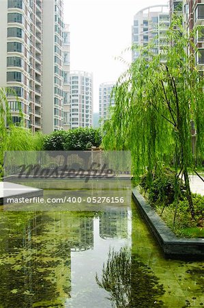 Central garden with water pond and summerhouse in a new Chinese residential district