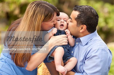 Happy Mixed Race Parents Playing with Their Giggling Son.