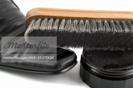 shoe cream , brush and black polish paste shoe isolated on white