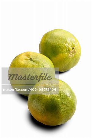 Tangerines, group of green color fruit isolated on white.